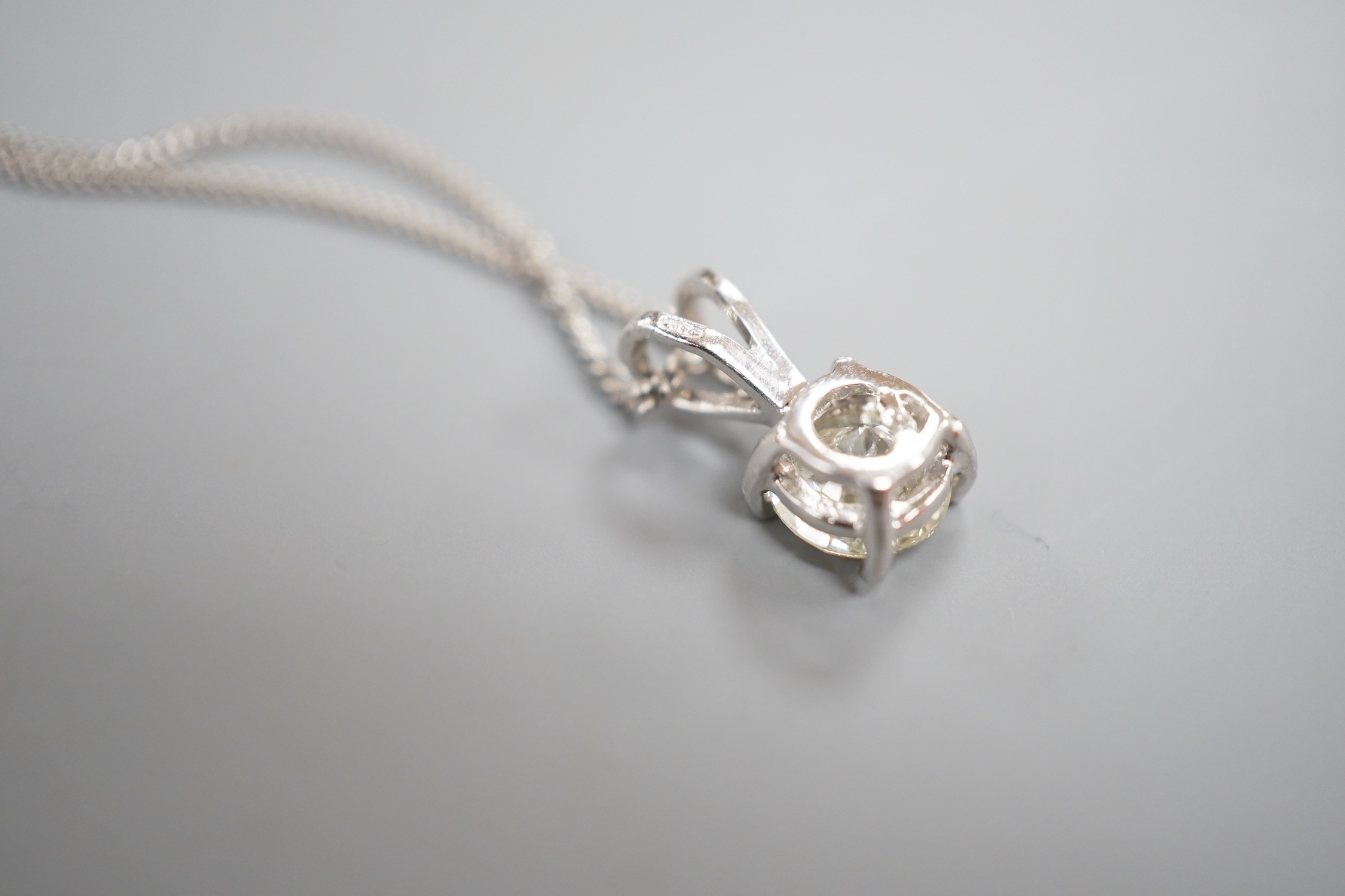 A modern 750 white metal and solitaire diamond set pendant, overall 14mm, on an 18ct white gold fine link chain, 44cm, gross weight 3.3 grams